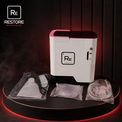 Restore Compact Oxygen Concentrator and accessories on a round table in a dark interior